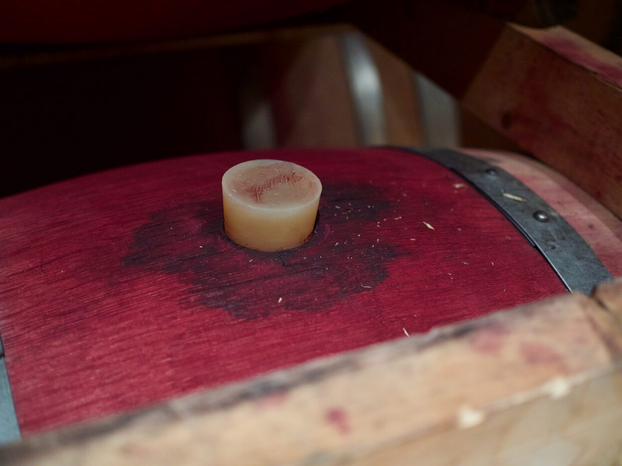 A cork on top of a wine barrel