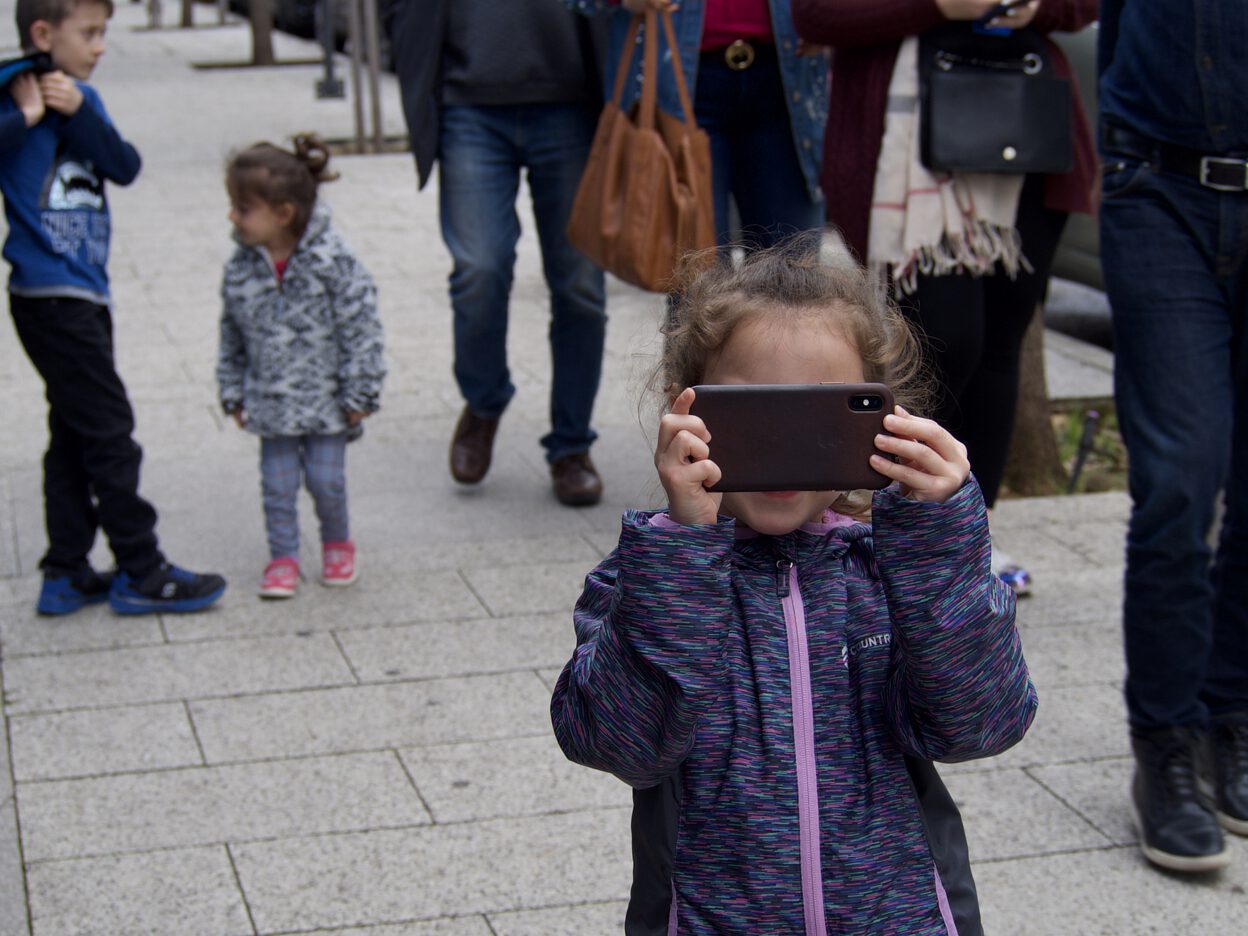 A girl taking a photo with an iPhone