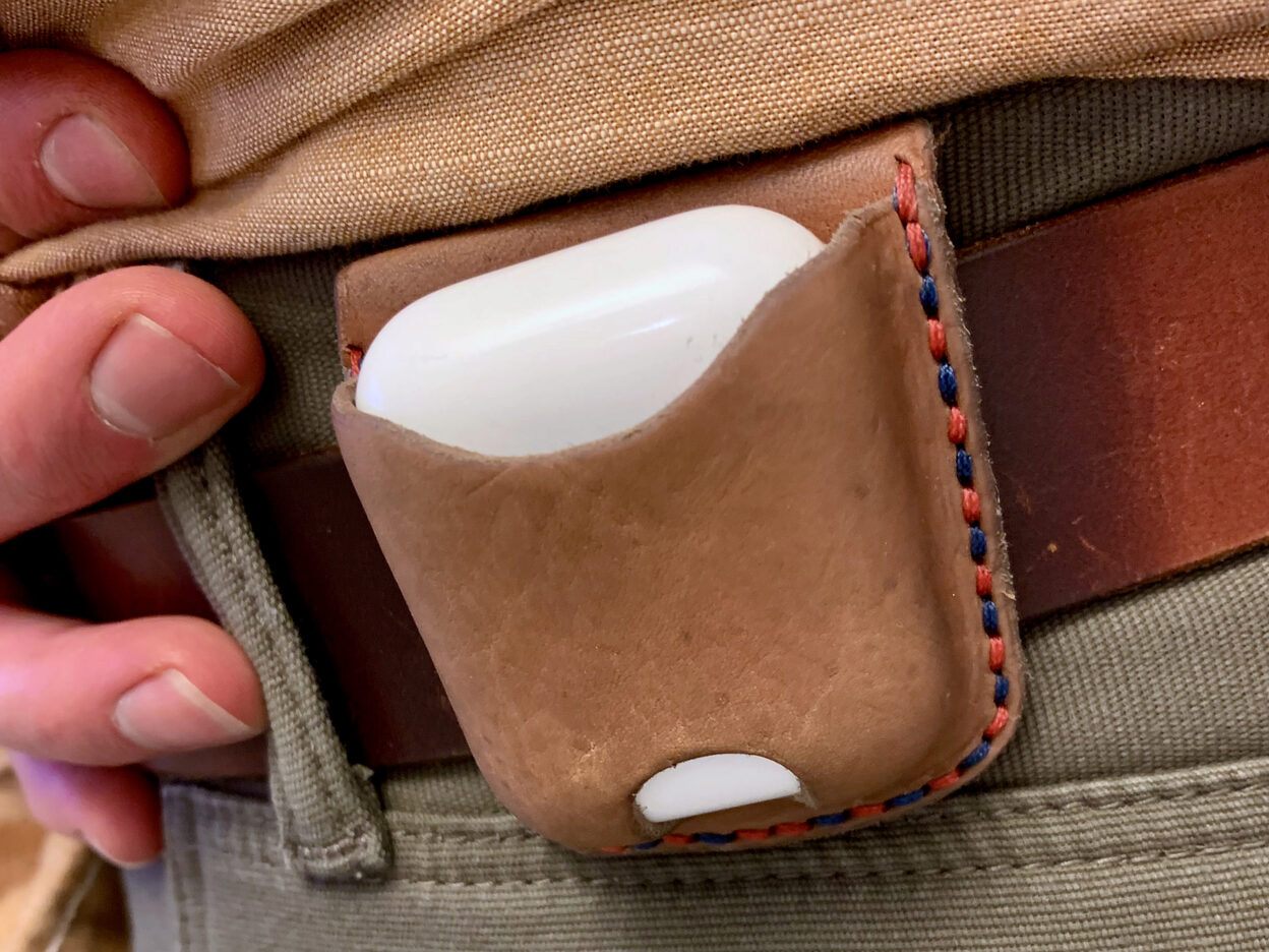 AirPods case on belt.